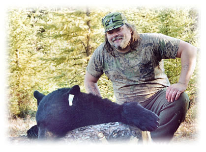 Photo of proud bear hunter and bear