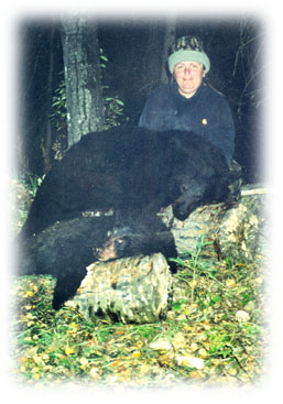 Photo of lady hunter and two black bear