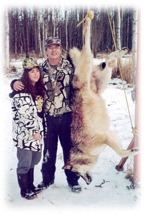 Photo of your hosts Beth and Steve Mahoney with massive wolf
